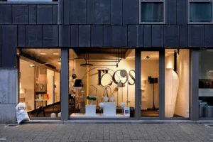 Contemporary retail storefront featuring large glass display windows and modern interior lighting.
